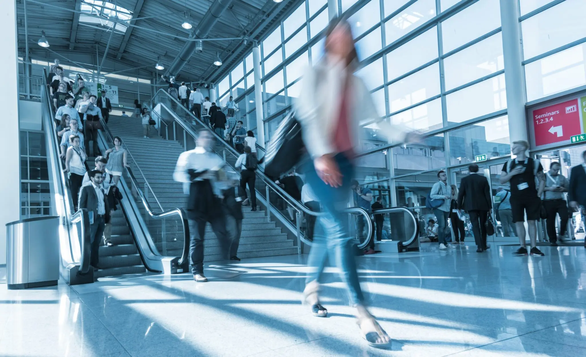 Busy airport terminal with travellers walking.