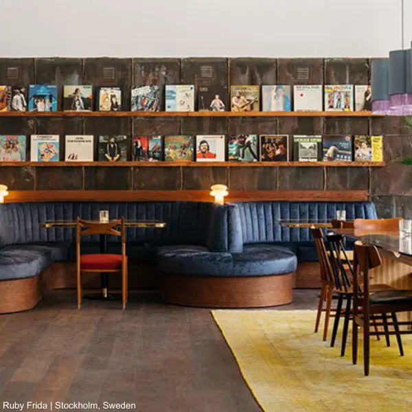 Business lounge with blue seats and vinyl records, ideal for travellers.